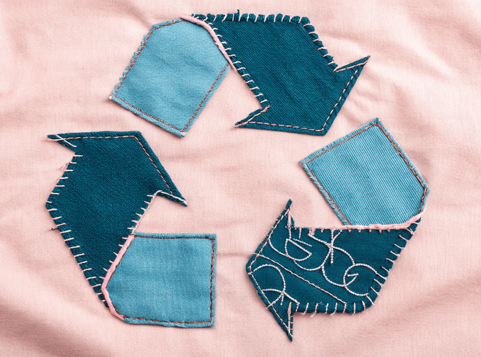 Recycling symbol made from fabric patches